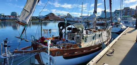 Bristol Channel Cutter 28 at a dock showing the boomkin, bulwarks and teak trim