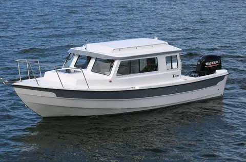 C-Dory 25 Cruiser at speed showing the pilothouse and side windows