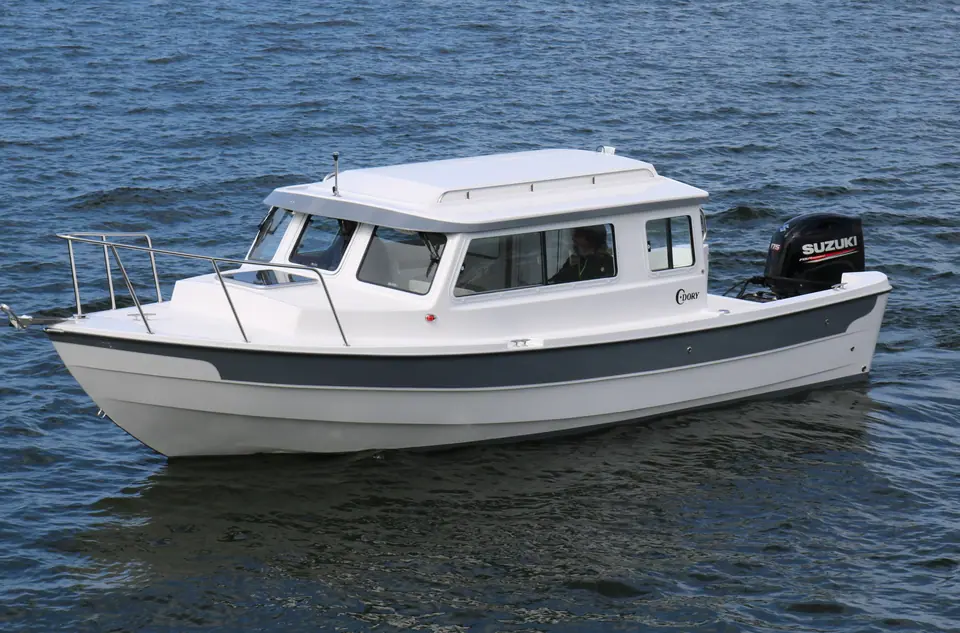 C-Dory 25 Cruiser at speed showing the pilothouse and side windows