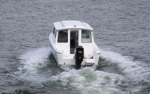 C-Dory 25 Cruiser seen from astern with its cockpit and outboard