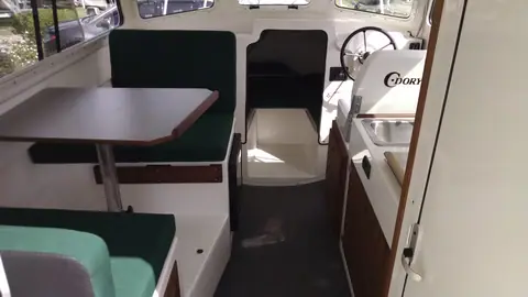 Cabin of the C-Dory 25 Cruiser with dinette and helm seat
