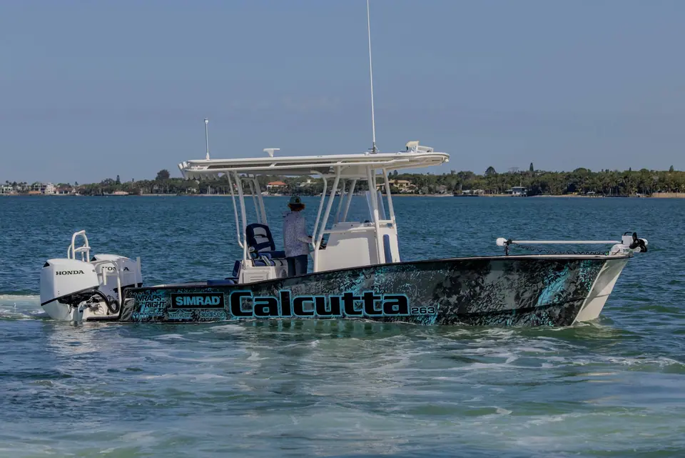 Calcutta 263 catamaran in side profile showing its wrapped hull and center console