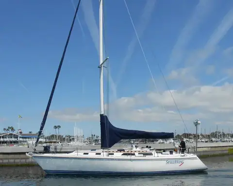 Catalina 42 in side profile at a marina wall with its mainsail covered