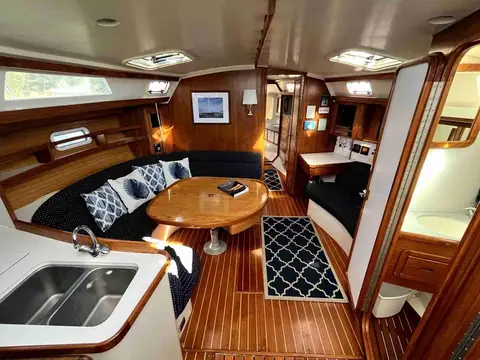 Catalina 42 main salon with a teak and holly sole, dinette and galley sink