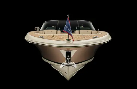 Chris-Craft Launch 27 seen head on, showing the flared bow, teak foredeck and windshield