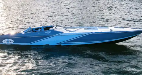 Cigarette 515 cruising past in side profile with a blue and silver hull