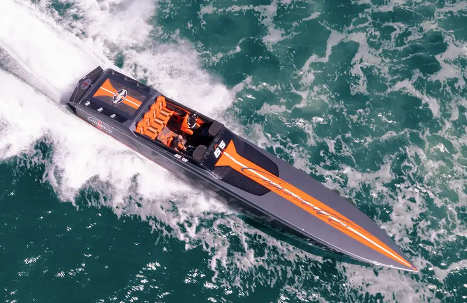 Cigarette 515 seen from above at speed with orange graphics and its open cockpit
