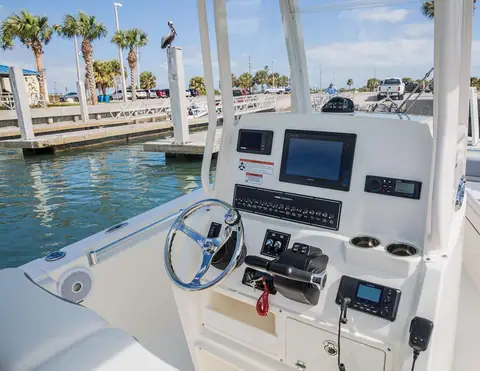 Cobia 240 CC helm console with a multifunction display, wheel and switch panel