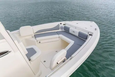 Cobia 240 CC bow with wraparound cushioned seating and a forward console seat