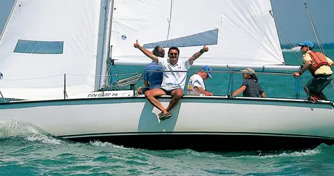 Colgate 26 sailing under main and jib with its crew on the rail