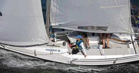 Colgate 26 sailing in New York Harbor with its open cockpit and crew visible