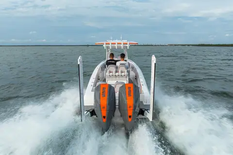 Concept 27 Open seen from astern at speed with twin outboards and wake
