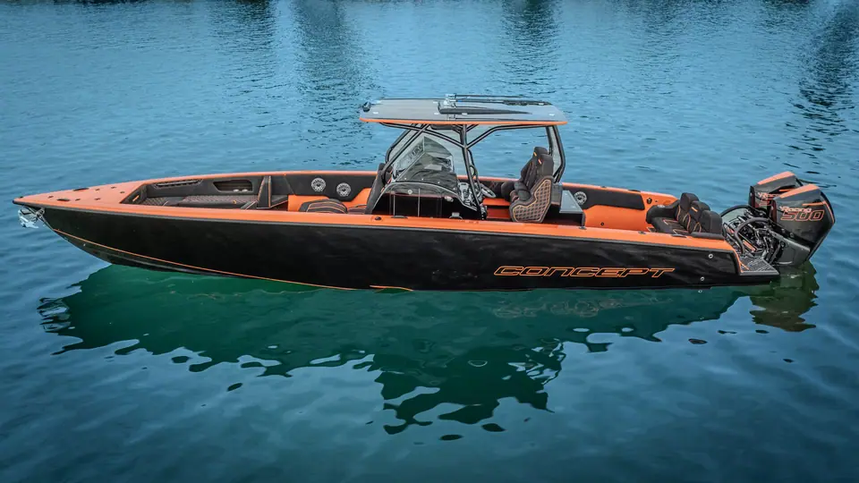 Concept 36 Open with a black and orange hull at rest on calm water