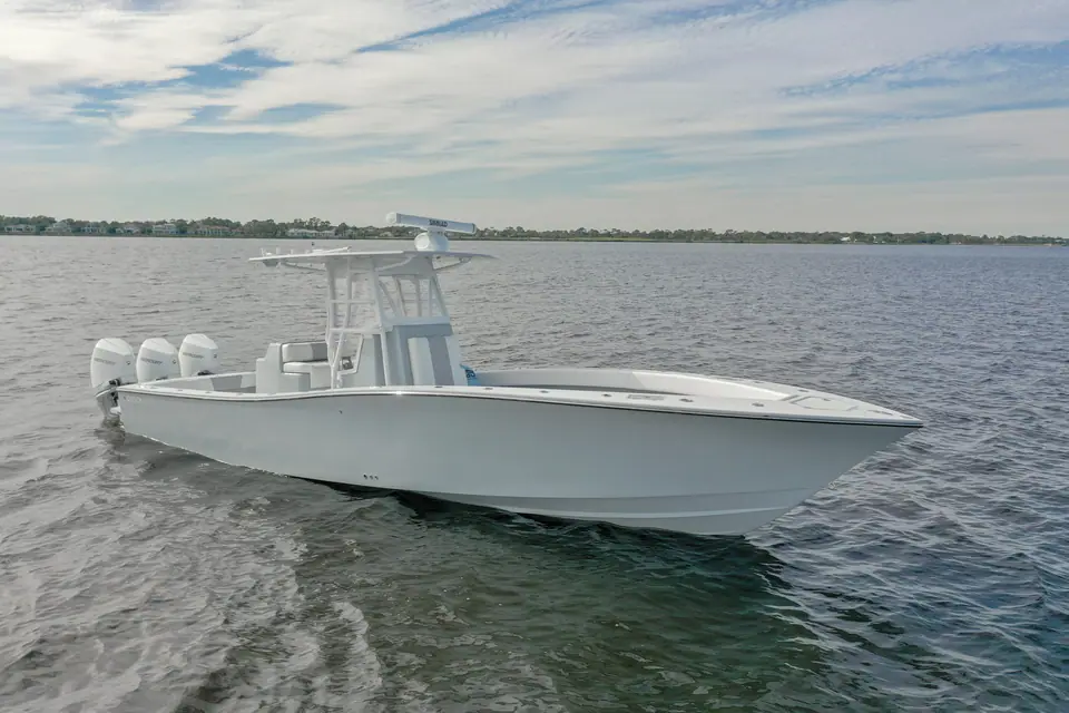 Conch 33 center console underway with triple outboards and a gray hull