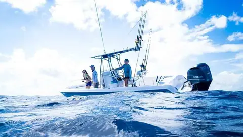 Anglers fishing from a Contender 24 Sport drifting on blue water