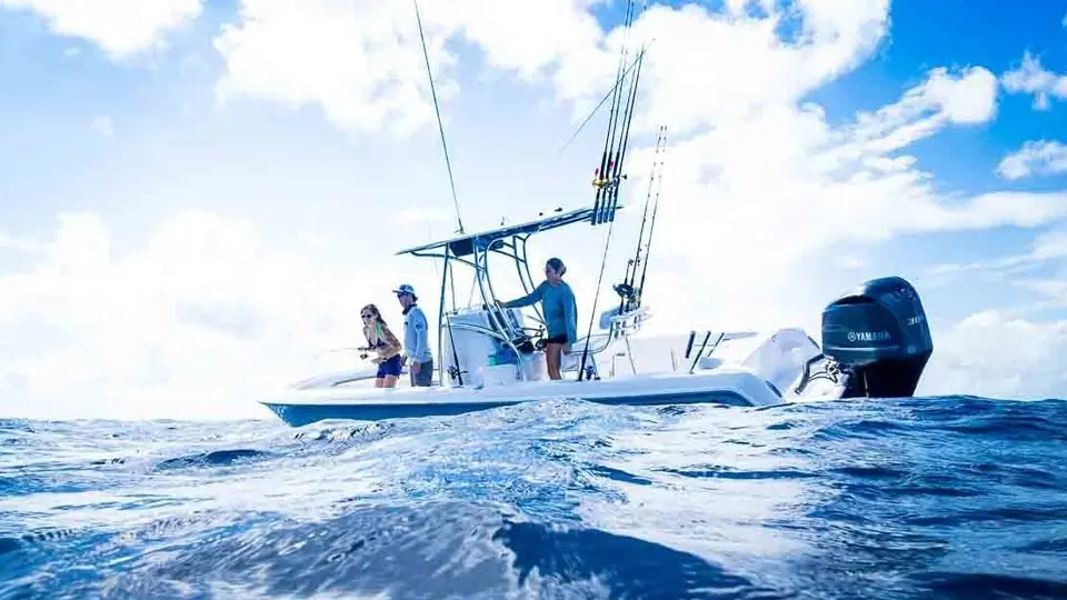 Anglers fishing from a Contender 24 Sport drifting on blue water