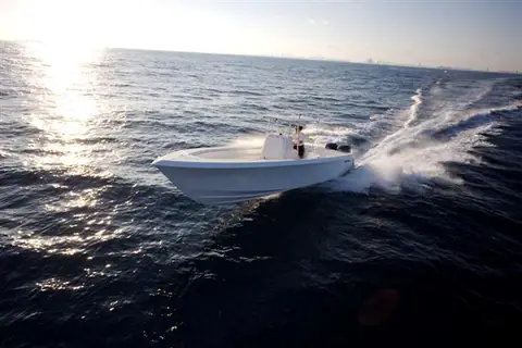 Contender 33 Tournament carving a turn offshore with the city skyline on the horizon