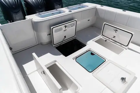 Contender 39 ST aft cockpit with in deck fish boxes and triple outboards
