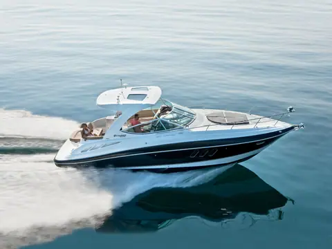 Cruisers Yachts 35 Express with a dark hull and radar arch running on calm water