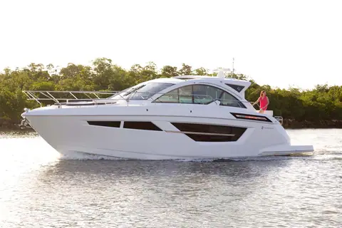 Cruisers Yachts 50 Cantius cruising in profile along a mangrove shoreline