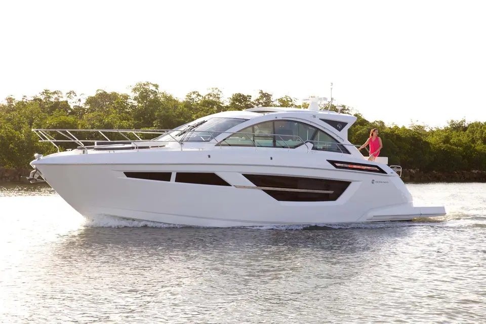 Cruisers Yachts 50 Cantius cruising in profile along a mangrove shoreline