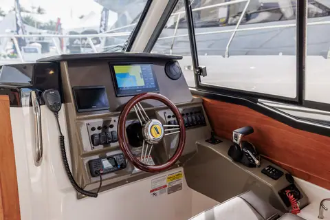 Cutwater C248 Coupe helm with wooden wheel, chartplotter and switch panel