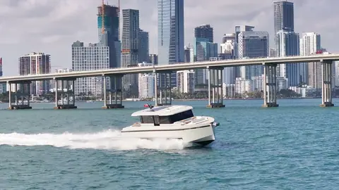 De Antonio D60 running past the Miami skyline and a causeway bridge