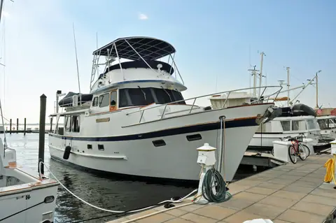 DeFever 49 Pilothouse trawler tied to a marina dock showing its flybridge and bow