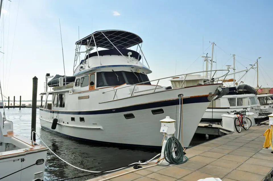 DeFever 49 Pilothouse trawler tied to a marina dock showing its flybridge and bow