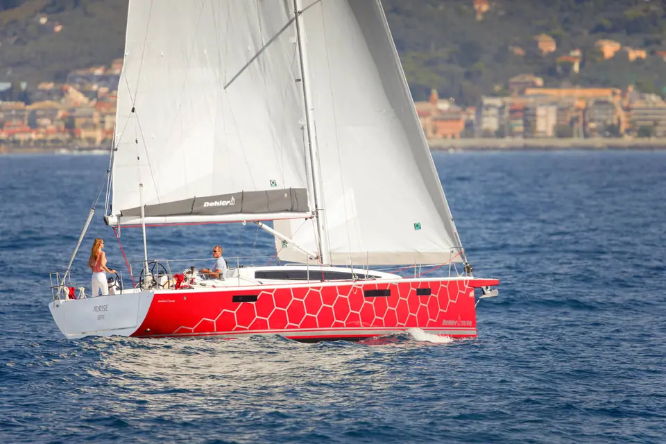 Dehler 38 SQ sailing in profile off an Italian coastal town