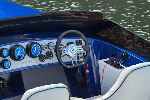 Donzi 22 Classic dashboard with blue gauges and a sport steering wheel