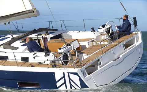 Dufour 470 cockpit with twin wheels, teak decks and crew sailing
