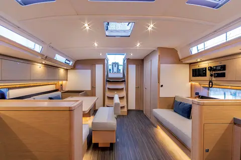 Dufour 470 saloon with L shaped settee, central bench and galley aft