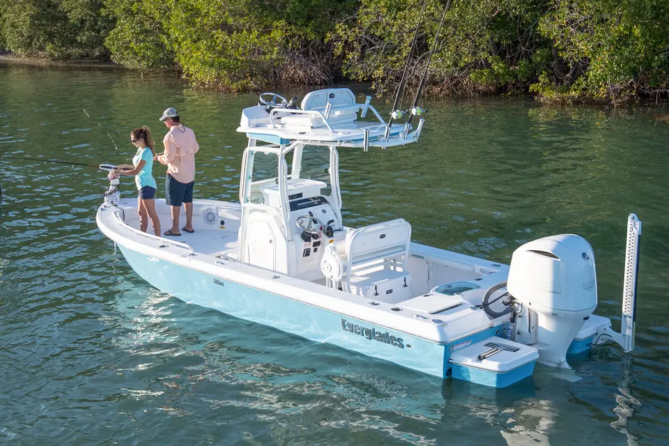 Everglades 243CC drifting near mangroves with anglers on the bow and a shallow water anchor