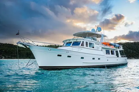 Fleming 65 at anchor showing its raised pilothouse and flybridge hardtop