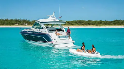 Formula 45 Yacht at anchor in turquoise water with a tender alongside