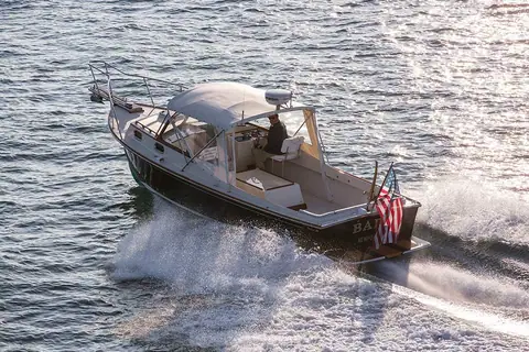 Fortier 26 running seen from astern showing the open cockpit and helm