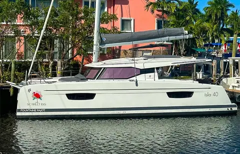 Fountaine Pajot Isla 40 in profile at a dock showing its hull windows and coachroof