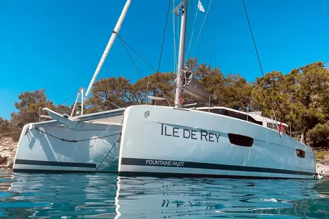 Fountaine Pajot Saona 47 at anchor in a wooded cove seen from the bow quarter
