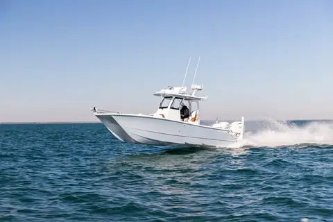 Freeman 28 catamaran center console running fast with twin outboards