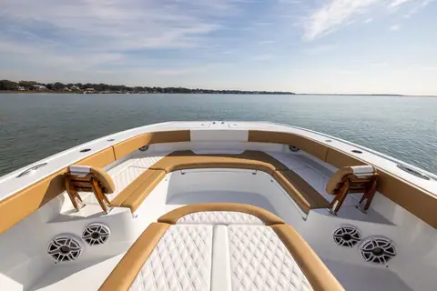 Freeman 32 bow seating with tan cushions and grab rails
