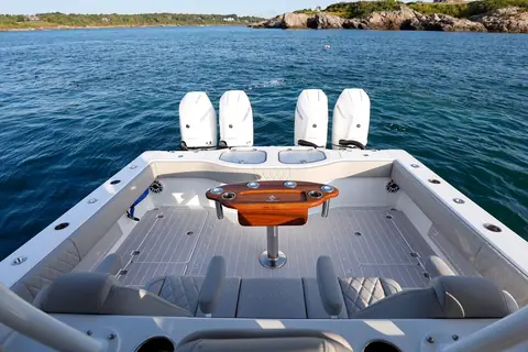 Freeman 42 aft cockpit with a teak rigging table and four outboards