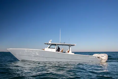 Freeman 47 catamaran center console running in profile on calm open water