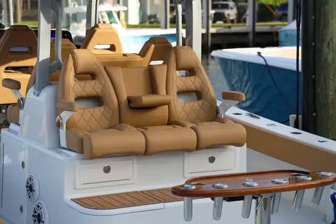 Helm seating of the Freeman 47 with tan diamond stitched bolsters and teak trim