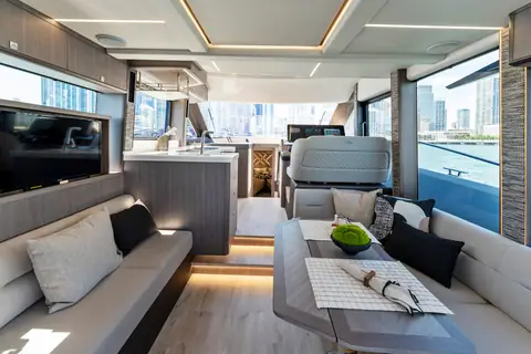 Main deck salon of the Galeon 440 Fly with dinette, galley and helm beyond