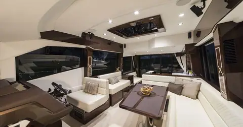 Main deck salon of the Galeon 500 Fly with helm, leather seating and dining table