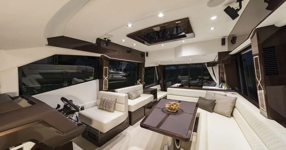 Main deck salon of the Galeon 500 Fly with helm, leather seating and dining table