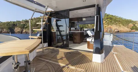 Aft cockpit of the Galeon 500 Fly with teak deck, table and open salon doors