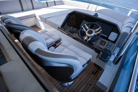 Flybridge helm of the Galeon 640 Fly with twin helm seats and teak sole