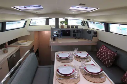 Saloon of the Garcia Exploration 45 with dinette, galley and forward facing chart table